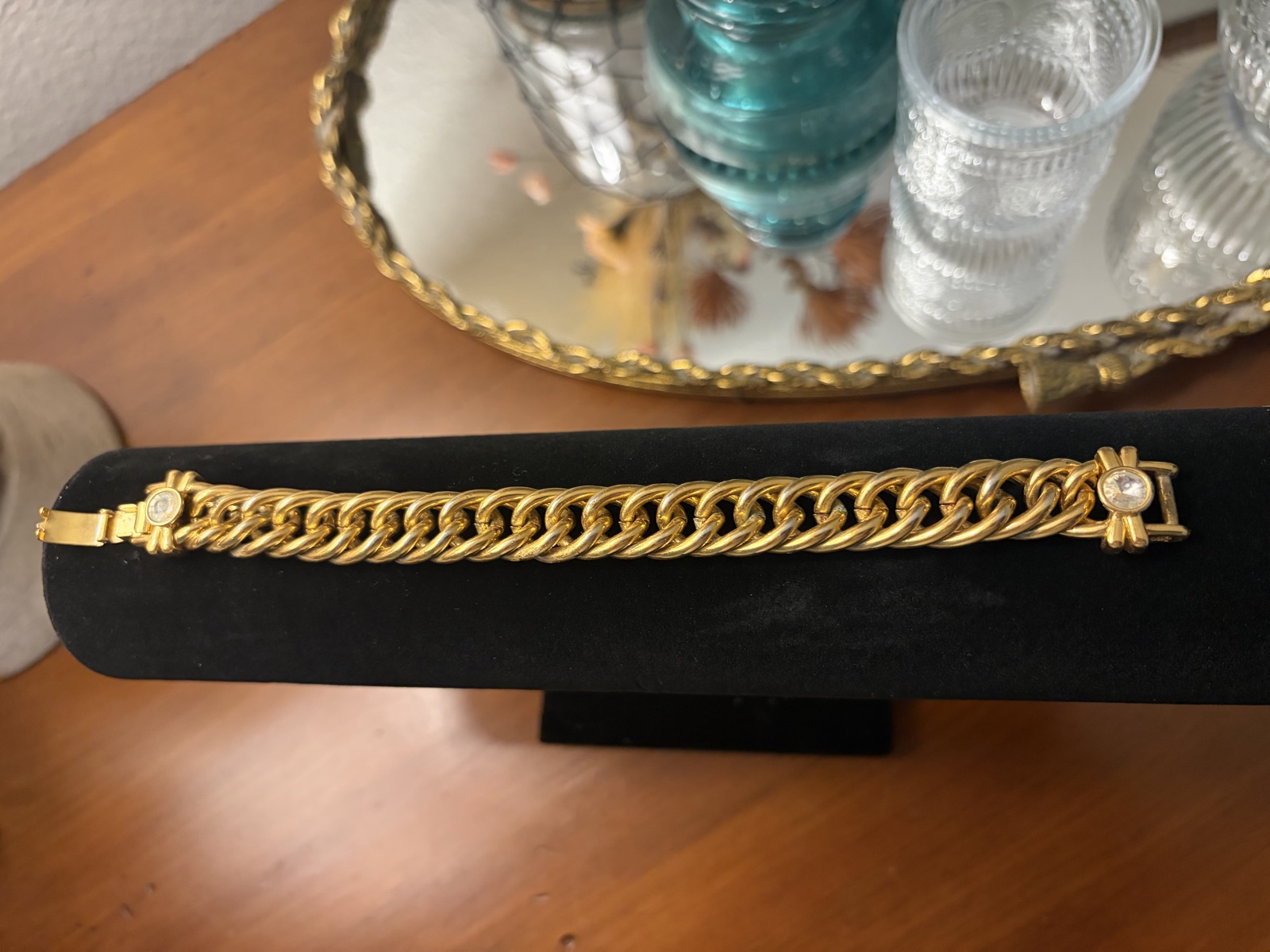 Gold-tone charm bangle with blue-green and red accents