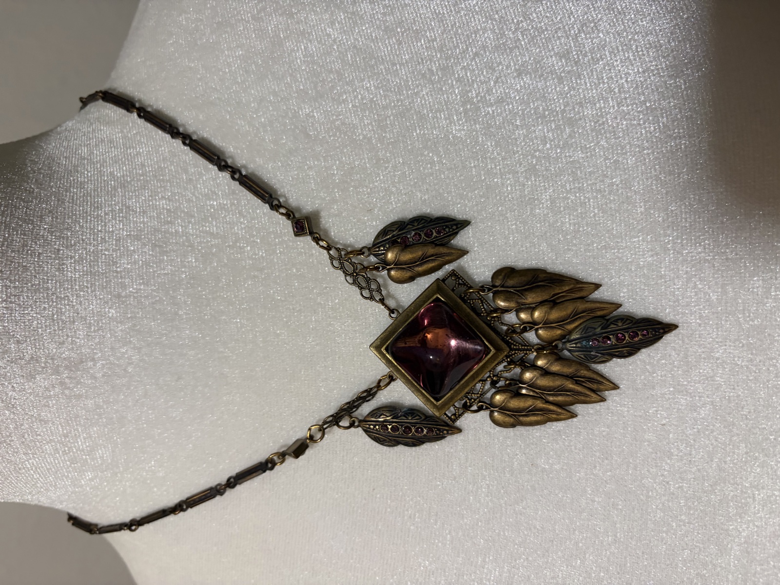 Gold-tone leaf statement necklace with purple center
