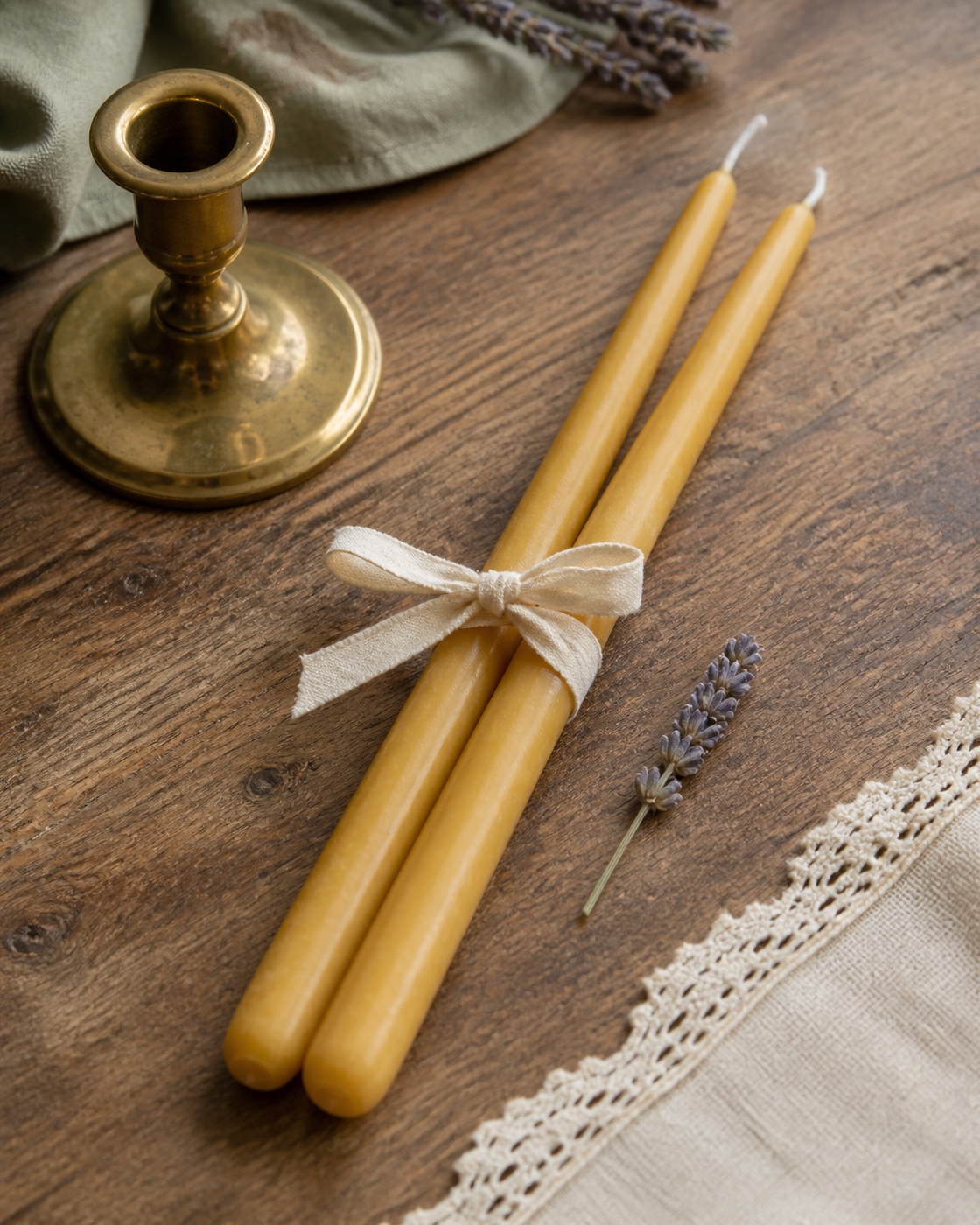 Pair of natural golden beeswax taper candles tied with cream cotton ribbon